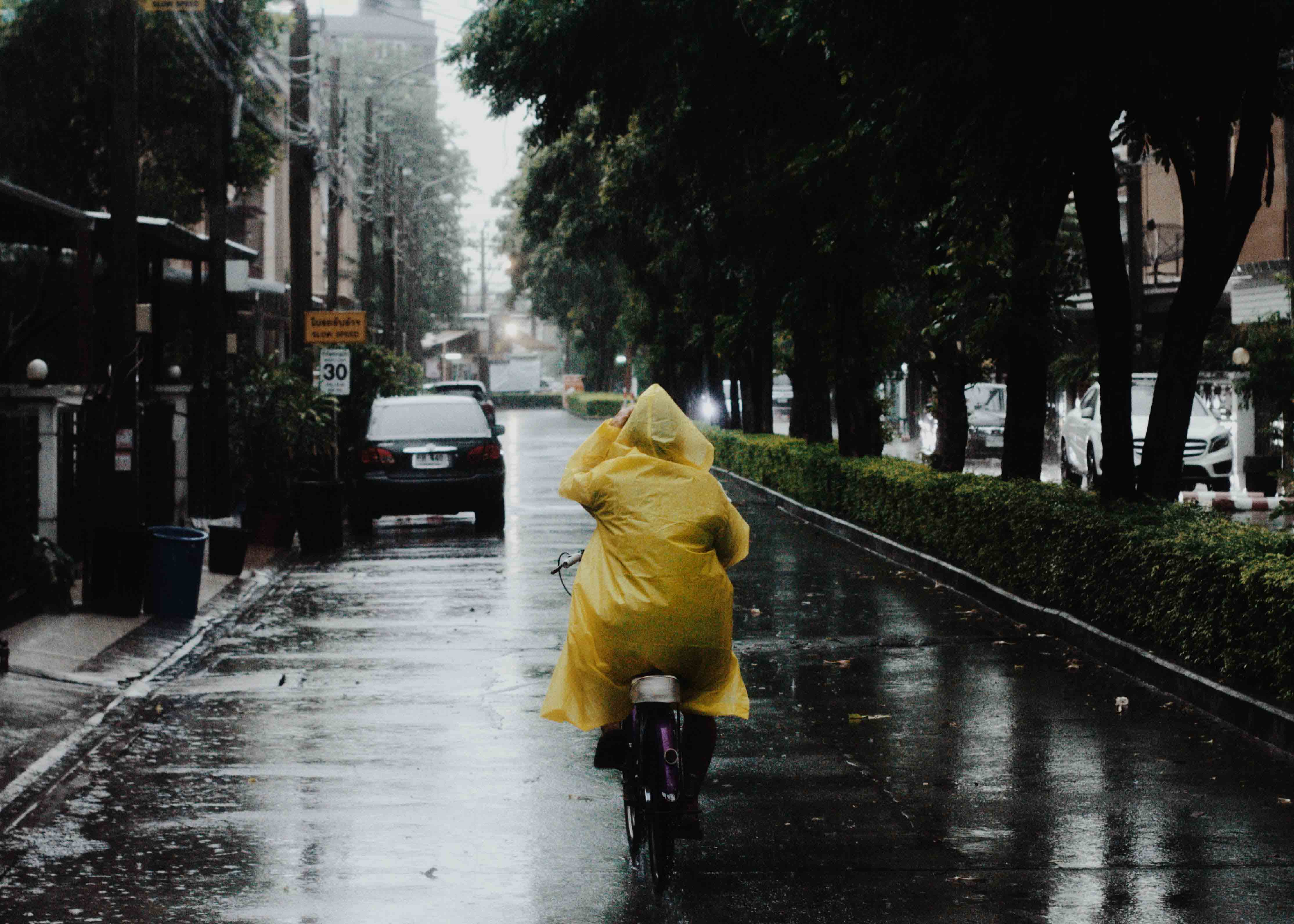 Lady in yellow raincoat, rainy day, Bangkok neighborhood
